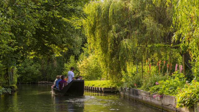 Personen in einer Barke auf einem der Wasserkanäle der schwimmenden Gärten von Amiens, Nordfrankreich. Copyright: CRTC Hauts-de-France, Stéphane Bouilland